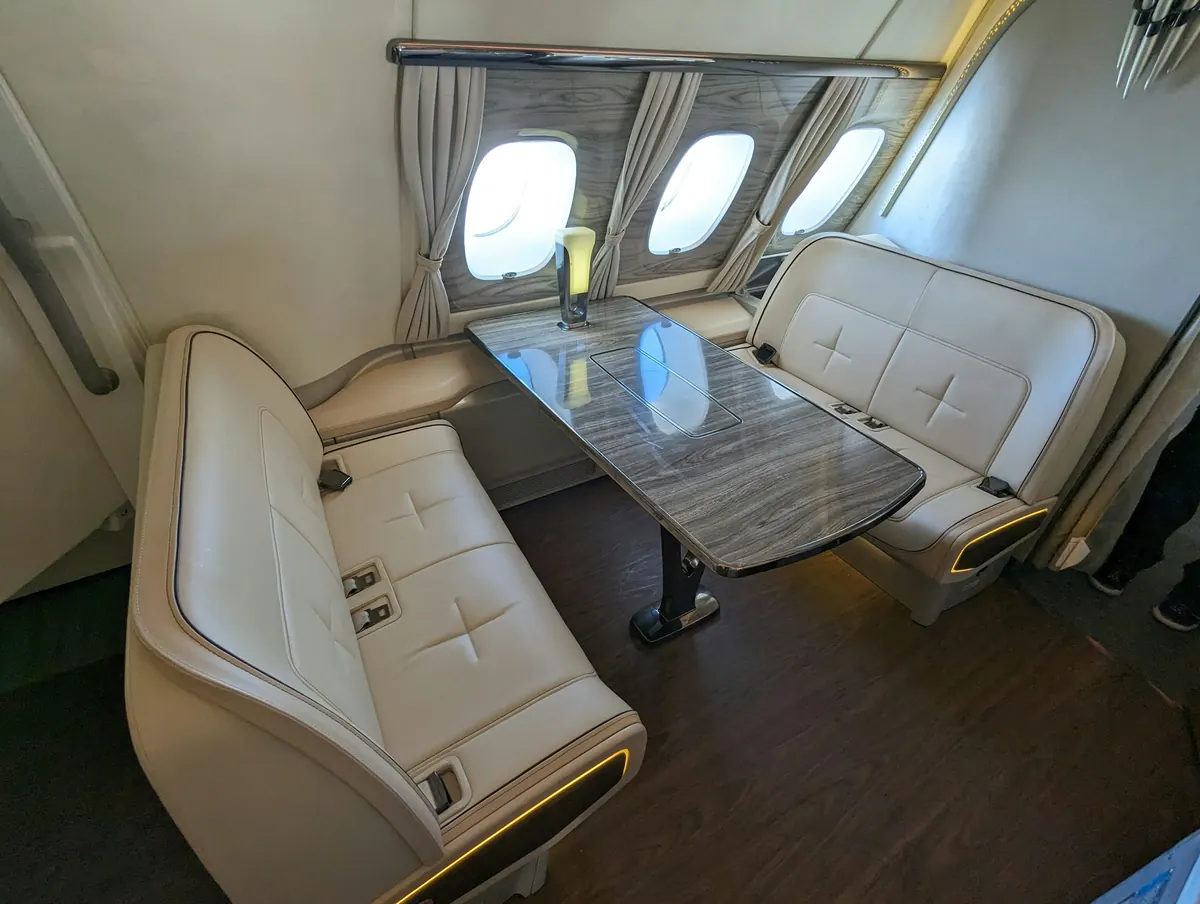 Club seats around a table in a private jet cabin